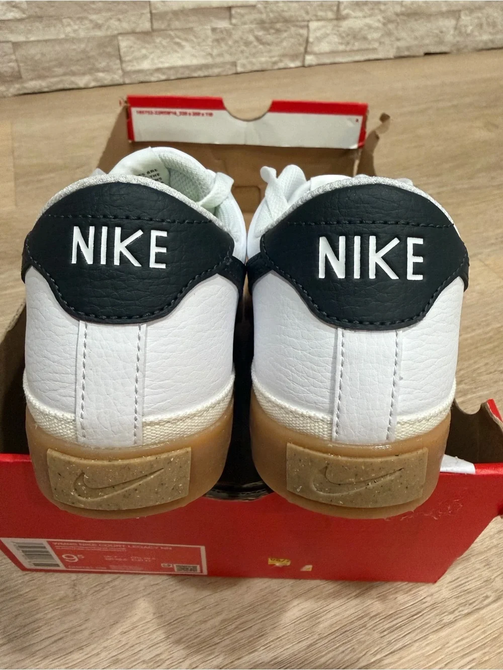 Nike Women's White Sneakers with Black Swoosh and Gum Sole